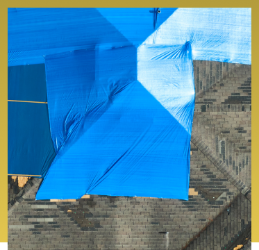 Blue beach umbrellas providing shade on stone steps near waterfront building