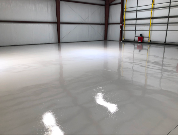 Empty industrial warehouse with polished concrete floors and metal framework